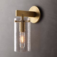 a light that is on the wall with a glass tube attached to it's side