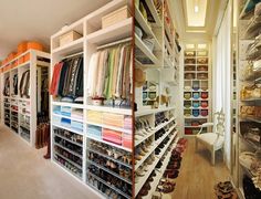 the closet is full of shoes and other items for sale on shelves in different colors