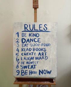 an easel with a sign on it that says rules to be kind of dance