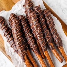 chocolate covered pretzels sitting on top of a piece of paper