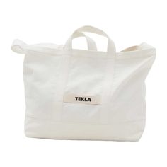 Tekla's beach bag is your ideal companion for sunny adventures. Made from thick cotton canvas, this versatile tote bag can be carried by its handles or sturdy shoulder strap. The small front pocket is perfect for storing sunscreen and sunglasses, while the large zippered interior pocket keeps towels, books, snacks and valuables safe from sand. Beyond beach days, the Tekla beach bag is also great for shopping trips, picnics or perhaps a visit to the gym. Bedding Packaging, Tekla Fabrics, Jun K, Make Fashion, Natural Blondes, Scalp Care, New Packaging, Eco Bag, Black Sand