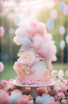 a pink and blue wedding cake with flowers on the top is surrounded by balloons in the background