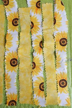 yellow sunflowers on green and white fabric