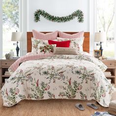 a bed in a room with christmas decorations on the wall