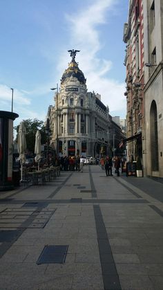 an empty city street with people walking on it