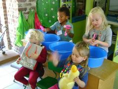 three children are playing with toys in a playroom