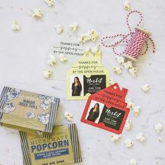 popcorn and movie tickets are scattered on a table with red, white and blue tags