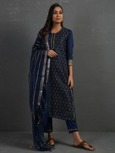 A gold hand block printed chanderi kurta in indigo with gota details in placket and cuff. The piece comes with a matching slip in mul and pants with elasticated - draw string adjustable waist band Kurta measurements (in Inches): Size S: Bust - 39", Waist - 38" Size M: Bust - 42", Waist - 41" Size L: Bust - 45", Waist - 44" Length: 47", Sleeve length: 17" Pant Measurements (in Inches): Size S: Waist - 30-32" Size M: Waist - 33-35" Size L: Waist - 36-38" Length: 35" Fabric: Chanderi (Cotton silk) Festive Designer Indigo Kurta, Bollywood Style Indigo Straight Kurta, Designer Wear Indigo Kurta, Indigo Kurta With Zari Work For Diwali, Indigo Anarkali For Navratri, Indigo Anarkali Traditional Wear For Navratri, Indigo Salwar Kameez With Zari Work For Navratri, Navratri Indigo Salwar Kameez With Zari Work, Indigo Cotton Silk Kurta For Eid