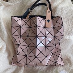 Baobao Issey Miyake Tote Bag This Bag Is Just So Awesomethe Large Nwt Carry All Bag Is So Cute.. It’s Never Ever Been Used And It’s Fresh Out Of Bloomingdales.. Also It’s Fun To Squish And Play With.. The Geometric Pattern Brings Out The Rock Star In Any Womanbrand New With Tags And Still Has All The Plastic On The Zips.. Guaranteed Authentic And Absolutely Beautifuli’m Going To Fill This Baby With Gifts From Sephora So Be Sure To Let Me Know Your Lip Color When You Purchase And What Makeup Bran Modern Pink Bag For Everyday Use, Modern Handheld Pink Shoulder Bag, Modern Pink Shoulder Bag For Evening, Modern Pink Evening Bags, Modern Pink Handheld Shoulder Bag, Pink Square Shoulder Bag With Dust Bag, Modern Pink Shoulder Bag For Shopping, Modern Pink Shoulder Bag, Modern Pink Shoulder Bag With Removable Pouch