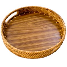 a round wooden tray with handles made out of wicker