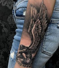 a man's arm with an angel tattoo on it and the words, be god