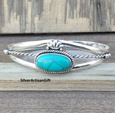 Turquoise is a mineral that is associated with the heart, throat, and third eye chakras. It is the birthstone for December and is associated with the zodiac signs Scorpio, Sagittarius, Aquarius, and Pisces. stone - Turquoise  material - 925 sterling silver  stone shape- -oval setting-  Bezel This is classy fine hand-crafted sturdy- Turquoise bangle . Turquoise Sterling Silver Bracelet Gift, Southwestern Style Round Cuff Bracelet As Gift, Round Turquoise Sterling Silver Bangle, Oval Turquoise Cuff Bracelet As Gift, Handmade Turquoise Sterling Silver Bracelet Gift, Spiritual Oval Sterling Silver Bracelet Gift, Spiritual Sterling Silver Oval Bracelet Gift, Handmade Turquoise Bangle For Gift, Southwestern Style Turquoise Bangle As A Gift