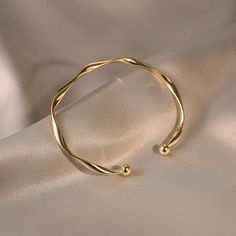 ✦ Our Simple Gold Wave Open Cuff Bangle Bracelet is a dainty and stylish accessory perfect for everyday wear. Crafted from high-quality materials and plated with a shiny gold finish, this bracelet features a unique wave design and an open cuff for comfortable wear. It makes a thoughtful gift for her, best friend or as a couple bracelet. ----------- DETAILS ------------ Diameter: 6.2cm- Size: Adjustable - Color: Gold/ Silver- Materials: Alloy, Gold Plating- SKU: HB637 Gold Adjustable Bangle, Minimal Bracelet Gold, Gold Adjustable Bracelet, Elegant Resizable Gold Cuff Bracelet, Minimalist Gold Cuff Bangle, Minimalist Bangle With Simple Design, Minimalist Gold-tone Bangle Bracelets, Bracelet Product Photography, Gold Minimalist Cuff Bracelet, Gold Plated