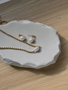 This little number consists of a precious freshwater pearl charm, finished with a timeless gold ball chain. Elegant & dainty enough to wear it on its own - or layer it with your own favorite staple necklace for a showstopper. 18K Gold Plated, Stainless Steel Length: 14.5' inch + 2' inch extender Minimalist Pearl Necklace With Beaded Chain, Dainty Round Bead Pearl Necklace, Dainty Gold Chain Necklace With Pearl Drop, Everyday Pearl Charm Necklace With Pearl Chain, Everyday Pearl Chain Charm Necklace, Minimalist Pearl Chain Necklace With Round Beads, Everyday Gold Pearl Charm Necklaces, Minimalist Gold Charm Necklace With Pearl, Dainty Everyday Pearl Chain Necklace