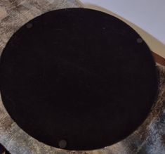 a round black object sitting on top of a table