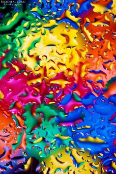 multicolored drops of water are seen in this image, with the colors being added to