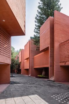 the building is made out of red bricks and has perfored screens on each side