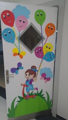 the door is decorated with many different colored balloons and faces, including a girl on a skateboard