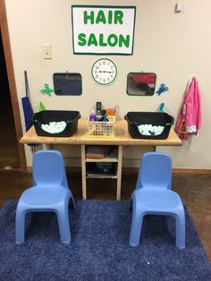 two plastic chairs sitting in front of a table with hair salon items on top of it