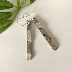 These dangly rectangular silver earrings are constructed from reticulated and smooth sterling. The light reflective ✨, textured surface of the reticulated silver combined with smooth brushed sterling sheet provides a striking contrast that makes these handmade earrings unique. A light patina has been applied to provide further contrast. The silver in these earrings is ♻️ recycled 925 sterling. The back of the earrings has a coarsely brushed finish. The ear wire is 20 gauge round sterling. ✅ To e Silver Rectangular Everyday Earrings, Everyday Silver Rectangular Earrings, Modern Silver Rectangular Earrings, Minimalist Silver Rectangular Earrings, Modern Silver Earrings With Rectangular Pendant, Modern Silver Rectangular Pendant Earrings, Hammered Silver Rectangular Jewelry, Rectangular Hammered Silver Jewelry, Rectangular Silver Hammered Jewelry