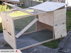 a chicken coop built into the side of a road with a ramp leading up to it