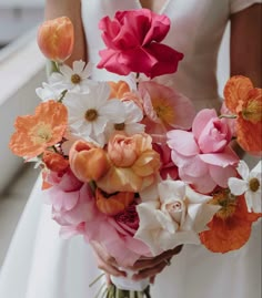 a bride holding a bouquet of flowers in her hands