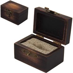 an open wooden box with two pieces of fabric in it and the lid opened to reveal a ring inside