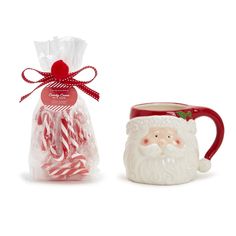 two mugs with candy canes in them next to a bag of candy canes