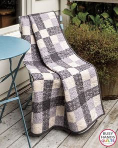 a black and white quilt sitting on top of a chair