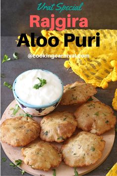 some food is sitting on a plate next to a bowl and flowers with the words, what special ragria aloo puri