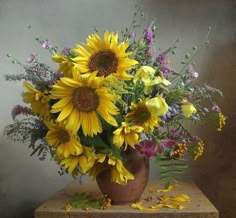 a vase filled with lots of yellow and purple flowers