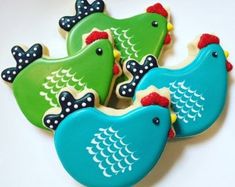 decorated cookies in the shape of birds on a plate