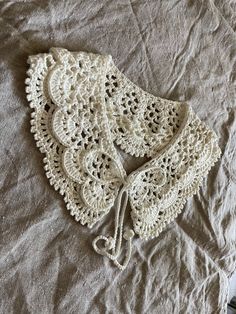 a crocheted bonnet laying on top of a bed