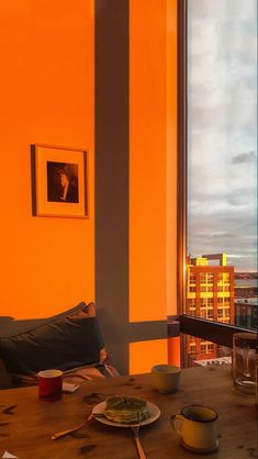 a table with food on it in front of a window overlooking a cityscape