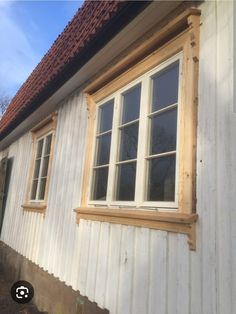 a white house with wood trim and windows