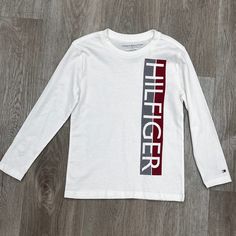 Clean Design In This T-Shirt From Tommy Hilfiger, Casual Dressing For Every Day. Crewneck, Ribbed Trim Imported Tagless Interior Long Sleeves, Printed Logo Attest And Side Machine Washable Fabric: Cotton Bundle And Save Tommy Hilfiger Long Sleeve Cotton T-shirt, Tommy Hilfiger White Crew Neck Top, White Cotton Tommy Hilfiger T-shirt, Tommy Hilfiger Long Sleeve Casual T-shirt, Casual Long Sleeve Tommy Hilfiger T-shirt, Tommy Hilfiger White Long Sleeve Tops, Casual Long Sleeve T-shirt By Tommy Hilfiger, Tommy Hilfiger White T-shirt With Graphic Print, Tommy Hilfiger White Cotton Shirt