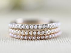 The 1.3 mm Cutie Fresh Seed Pearls Solid 10K, 14k Gold Daily Stocking Ring  vintage wedding band is crafted from 10K or 14K gold and detailed with white seed pearls.  This delicate, versatile piece is perfect for everyday wear, and makes a classic birthstone  for the bride-to-be. With its timeless design, the ring is a great addition to any wardrobe. Condition: Brand New Metal Purity: 10k, 14k rose gold  Stone : Fresh Pearl half Eternity wedding band ( 1.3 mm x 20 pcs)  Band Width : 1.5mm  Stand Stackable Pearl Rings, Pearl Band Ring, Pearl Wedding Band, Pearl Stacking Ring, Pearl Wedding Bands, Grandma Chic, Natural Pearl Ring, Crochet Mat, Half Eternity Wedding Band