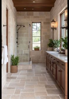 a large bathroom with stone floors and walls