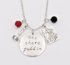 a necklace with charms that say hey there puddin and the key to my heart