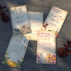 four different wedding pamphlets on a wooden table with flowers and leaves around the booklets