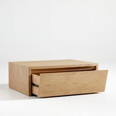 a wooden box with two drawers sitting on top of it