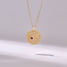 Introducing our Ruby Moon & Star Circle Charm Necklace, a celestial-inspired piece handcrafted with exquisite detail and elegance. Crafted from 14k solid yellow gold, this pendant features a captivating moon and star design encircling a genuine pink ruby birthstone disc, adding a touch of celestial beauty to your ensemble. The radiant pink ruby symbolizes love, passion, and vitality, making it the perfect birthstone for those born in July or anyone who appreciates its vibrant hue. 𝐈𝐭𝐞𝐦 𝐃𝐞? Celestial Yellow Gold Jewelry With Moon Phase, Celestial 14k Gold Medallion Jewelry, Celestial 14k Gold Birthstone Jewelry, Celestial Style 14k Gold Birthstone Jewelry, Celestial Pendant Jewelry That Is Tarnish Resistant, Celestial Round Pendant Jewelry With Tarnish Resistance, Celestial Pendant Jewelry, Tarnish Resistant, Celestial Jewelry With Tarnish Resistant Round Pendant, Celestial Round Pendant Jewelry Tarnish Resistant