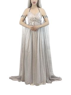 a mannequin dressed in a silver dress and headdress, with her hands on her hips