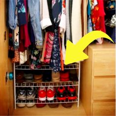 an open closet with clothes and shoes hanging on the shelves next to it is a yellow arrow pointing up