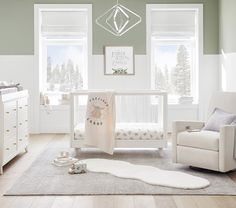 a baby's room is decorated in white and green tones, including the crib