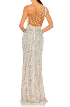 A lace-up back adds mesmerizing style to this glittering gown adorned by sequins and beads that will turn heads as you twirl the evening away. 62 1/2" length One-shoulder neck Sleeveless Lined 100% polyester Spot clean Imported Asian Owned/Founded Backless Embellished Gown For Prom, Embellished Backless Sequin Fabric For Prom, Glamorous Sequin Dress With Beaded Straps For Prom, Prom Evening Dress With Beaded Straps For Party Season, Sparkling Backless Evening Dress For Gala, Sparkling Backless Evening Dress For Wedding, Glamorous Lace-up Back Evening Dress For Prom, Champagne Sequin Evening Dress For Prom, Party Gown With Lace-up Back For Prom Season