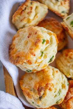 small biscuits with cheese and herbs in a white dish on a wooden table top, ready to be eaten