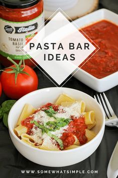 pasta with tomato sauce and parmesan cheese in a white bowl on a black table