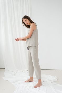 "When ordering you can choose to have the \"PANTS\" or \"TOP\" only or the whole \"PAJAMA SET\" of both items. When buying a set you save 5 euro. Soft EVA pajama pants with two side pockets and elastic waistband. UMA sleeveless top in natural linen. TOP: - length is ± 61 cm (24\") (depends on size) - straight cut - loose fit NOTE: This top is oversized, please have this in mind when choosing your size. BOTTOM: - outseam is ± 98 cm (38.5\") (depends on size) - inseam is ± 70 cm (27.5\") - elastic Linen Pajama Set, Linen Nightgown, Linen Sleepwear, Linen Sleeveless Top, Linen Shorts Women, Linen Top Women, Linen Pajamas, Pants Linen, Linen Tank Top