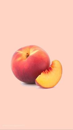 two peaches with one sliced in half on a pink background